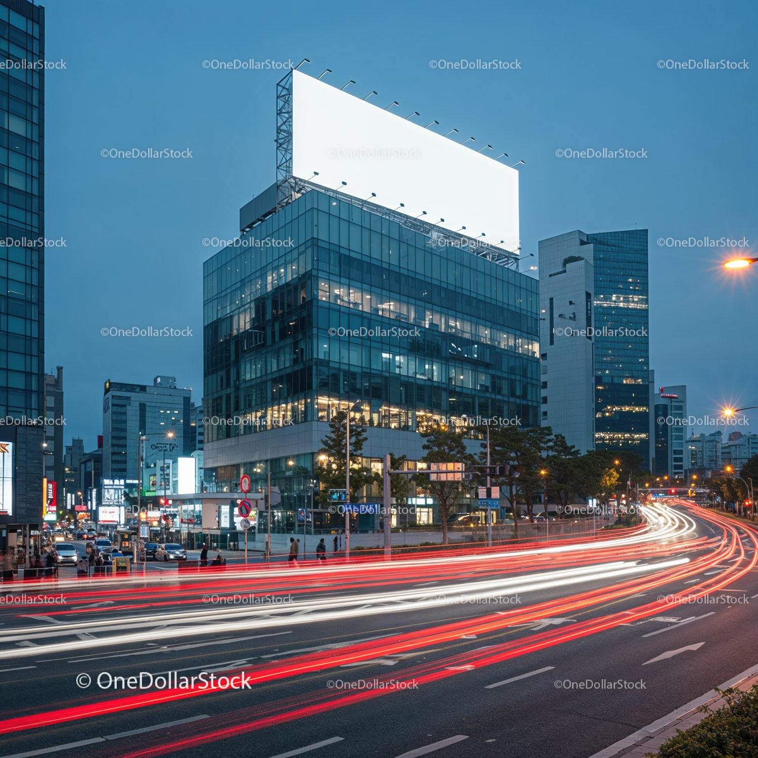 City street with illuminated billboard and light trails