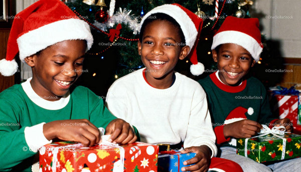 Three Boys Wearing Santa Hats Opening Christmas Gifts