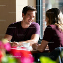 Couple enjoying a warm coffee date in bright cafe