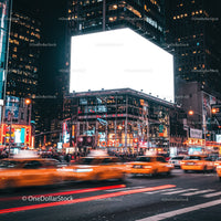 Busy city street with bright billboard and moving taxis