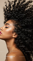 Profile of Woman with Voluminous Curly Hair and Glowing Skin