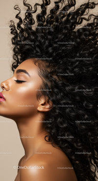 Profile of Woman with Voluminous Curly Hair and Glowing Skin