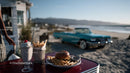 Vintage Car and Beachside Outdoor Dining Scene with Burger and Milkshake