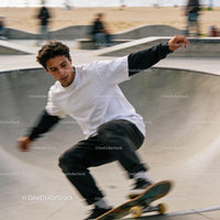Young man performing a skateboard trick at skatepark