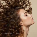 Profile of woman with voluminous curly hair on beige background
