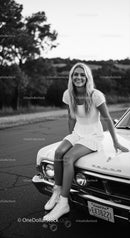 Smiling young woman in white dress with roller skates