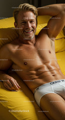 Smiling man relaxing on vibrant yellow bedding