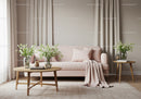 Elegant living room with soft pink sofa and fresh flowers