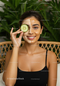 Young Woman Enjoying Facial Mask with Cucumber Slice in Spa Setting