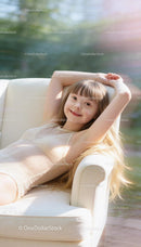 Smiling Girl with Down Syndrome Relaxing on Couch