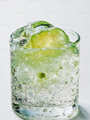 Refreshing sparkling water with cucumber slice closeup