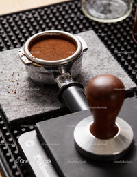 Freshly Ground Coffee in Portafilter with Espresso Tamper