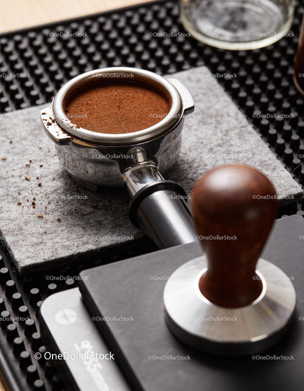 Freshly Ground Coffee in Portafilter with Espresso Tamper
