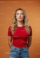 Blonde woman in red t-shirt looking thoughtfully upward