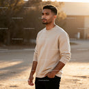 Thoughtful young man standing outdoors in warm light