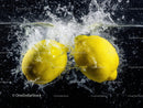 Two Lemons Splashing into Water in a Dynamic Fresh Citrus Scene