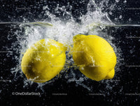 Two Lemons Splashing into Water in a Dynamic Fresh Citrus Scene