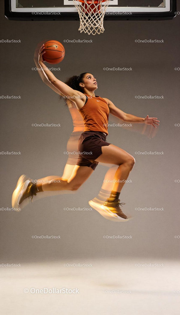 Female Basketball Player Jumping for Dunk in Studio