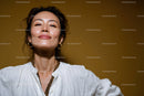 Confident Woman with Gold Jewelry Smiling in White Blouse Portrait