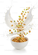 Breakfast cereal with milk splash and nuts in bowl