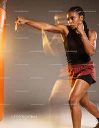 Athletic woman practicing boxing punch with speed