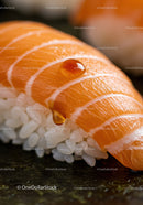 Close up of fresh salmon nigiri with soy sauce droplets