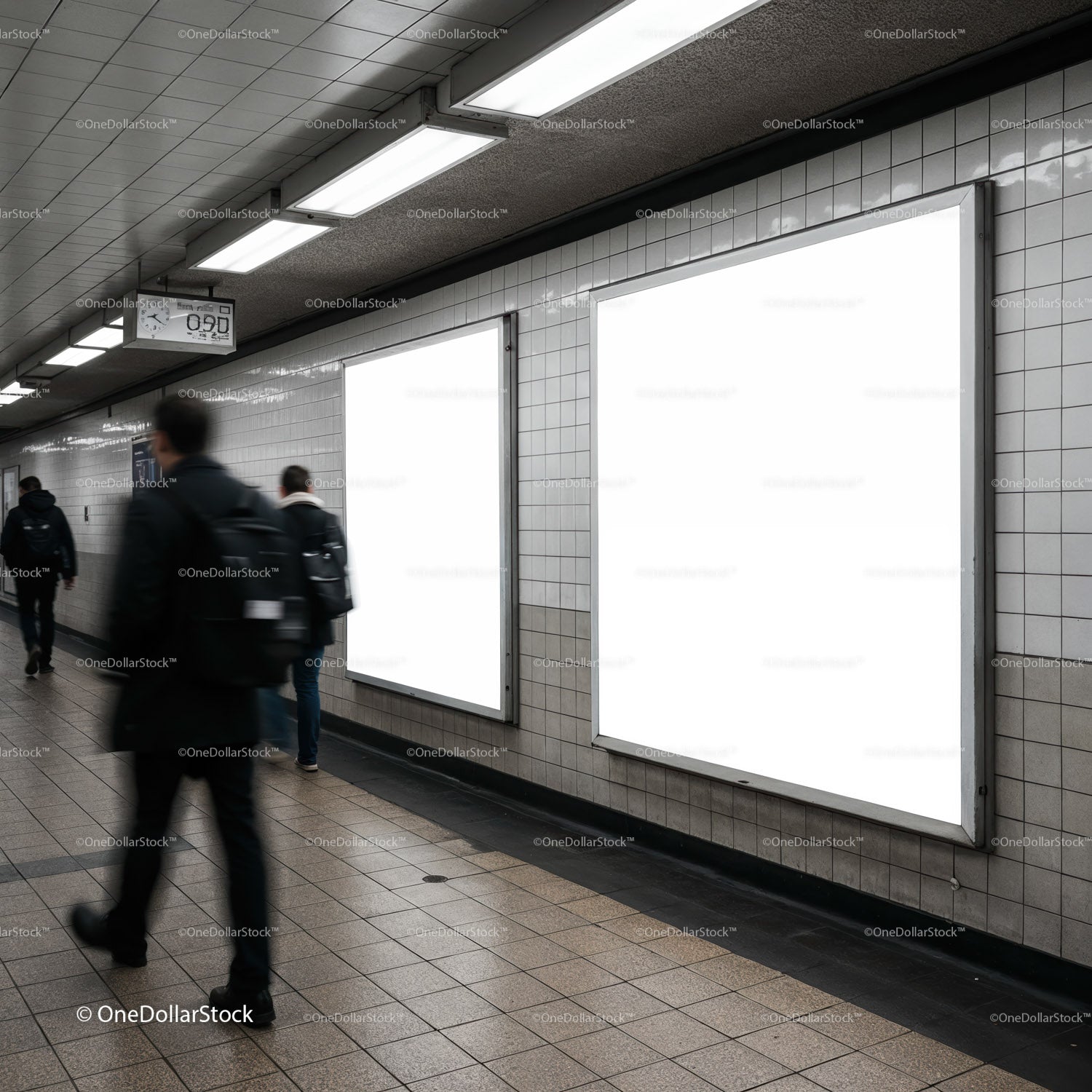 Commuters walking past blank advertising posters in subway corridor