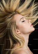 Blonde woman with flowing hair and closed eyes profile