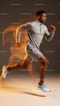 Focused Male Athlete Performing Sprint in Motion Blur