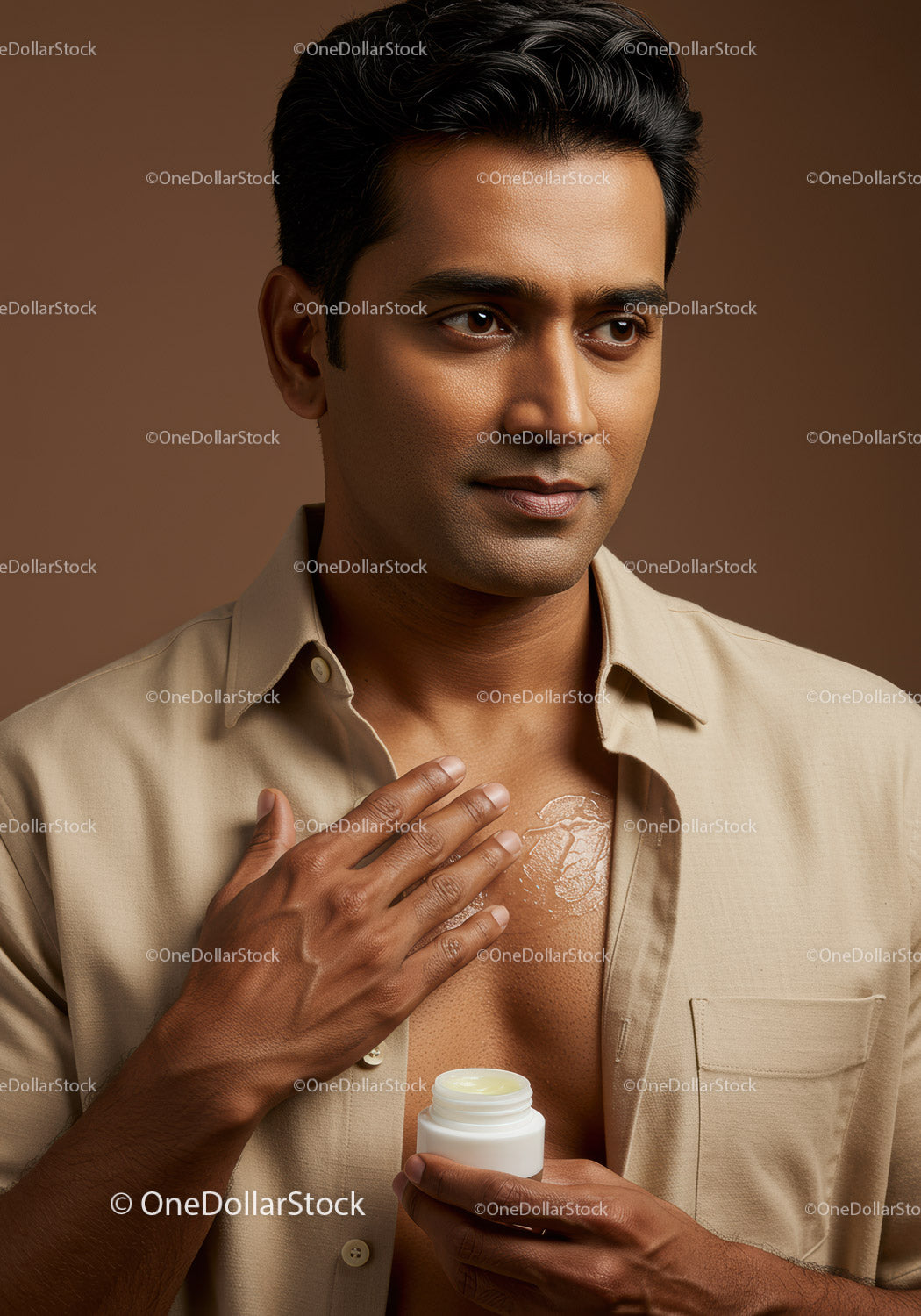 Male Applying Lotion to Chest for Skincare Routine in Studio