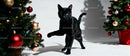 Curious black cat exploring festive Christmas decorations