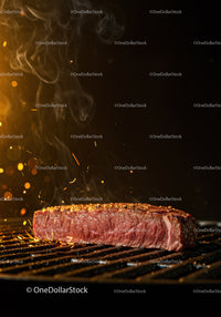 Close-up of juicy steak cooking on hot grill