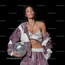 Stylish Woman in Metallic Outfit Holding Disco Ball for Modern Fashion