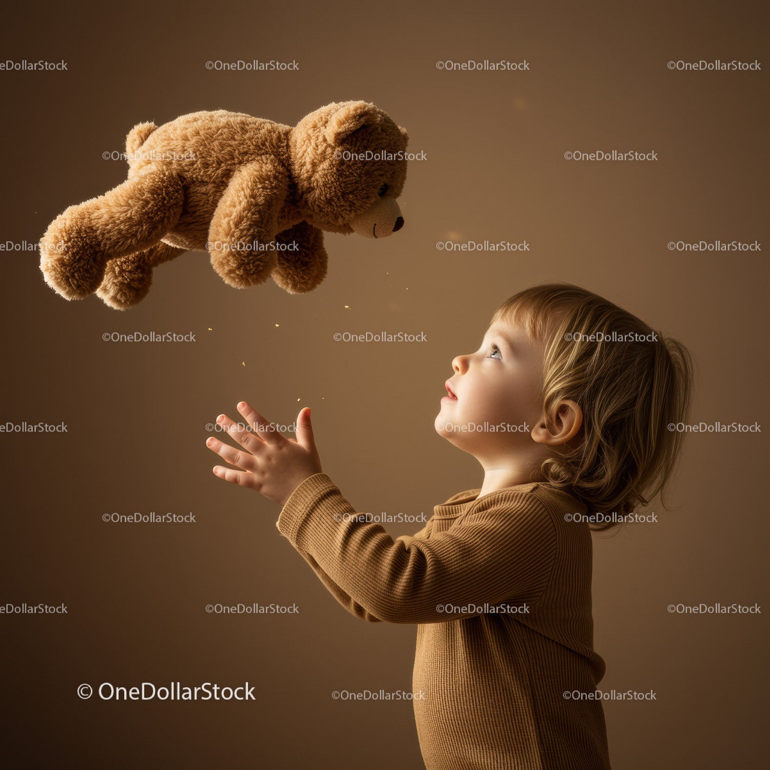 Curious toddler reaching for floating teddy bear