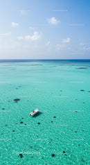 Bright Turquoise Ocean with Small Boat Under Blue Sky