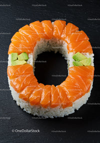 Salmon and avocado sushi ring on black slate plate
