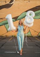 Smiling young woman celebrating eighteenth birthday outdoors