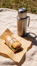 Freshly Wrapped Sandwich with Stainless Steel Thermos Outdoors
