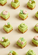 Assorted Green Pistachio Mini Cakes with Cream Decorations