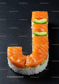 Sushi shaped like letter J with salmon and avocado