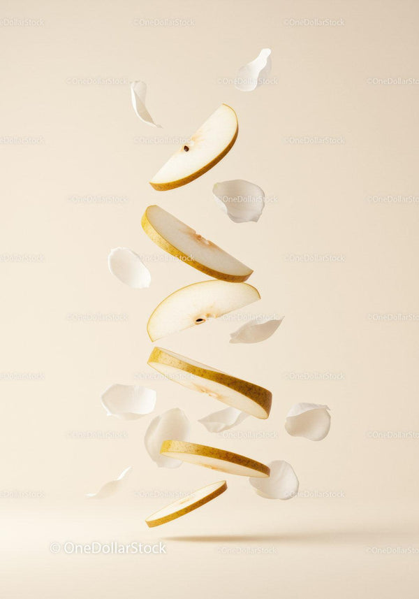 Floating slices of fresh pear with delicate petals