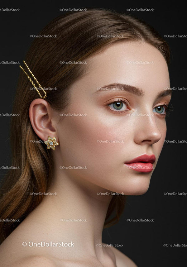 Elegant Young Woman with Pearl Earrings and Gold Hairpins in Studio
