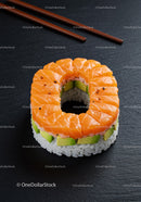 Circular Sushi Roll with Salmon and Avocado on Black Plate
