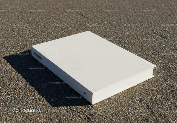 Minimalist white book on textured asphalt surface JPG Mockup Image