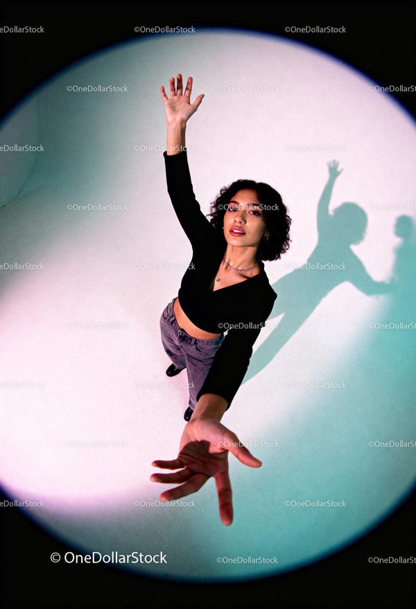 Young woman reaching up with dynamic expressive pose