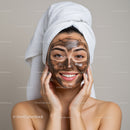 Young Woman Relaxing with Facial Mask and Towel on Head