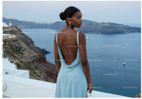 Elegant Woman in Blue Dress Overlooking Sea View