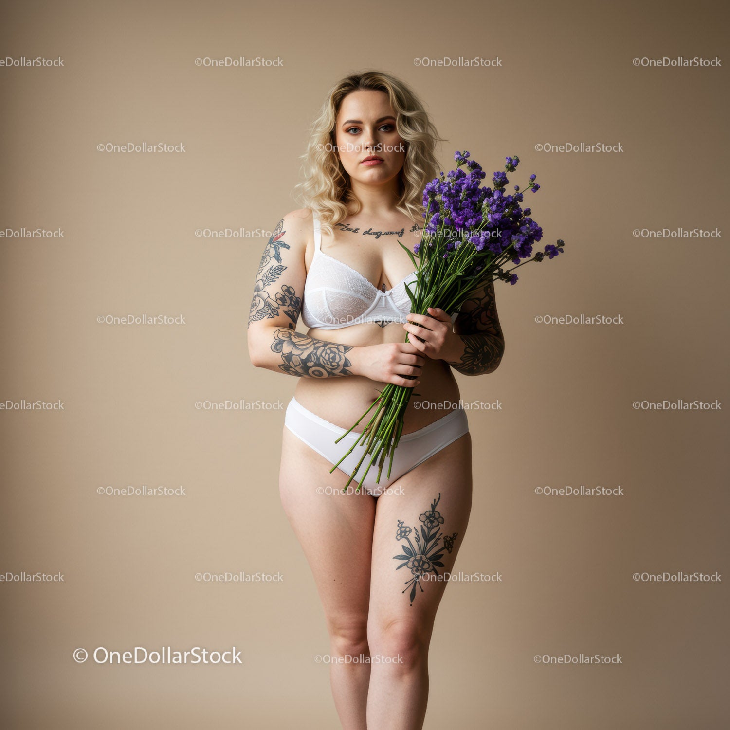Elegant Tattooed Woman Holding Purple Flowers in White Lingerie