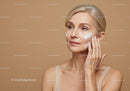 Elegant Mature Woman Applying Skincare Cream for Radiant Skin