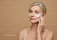 Elegant Mature Woman Applying Skincare Cream for Radiant Skin